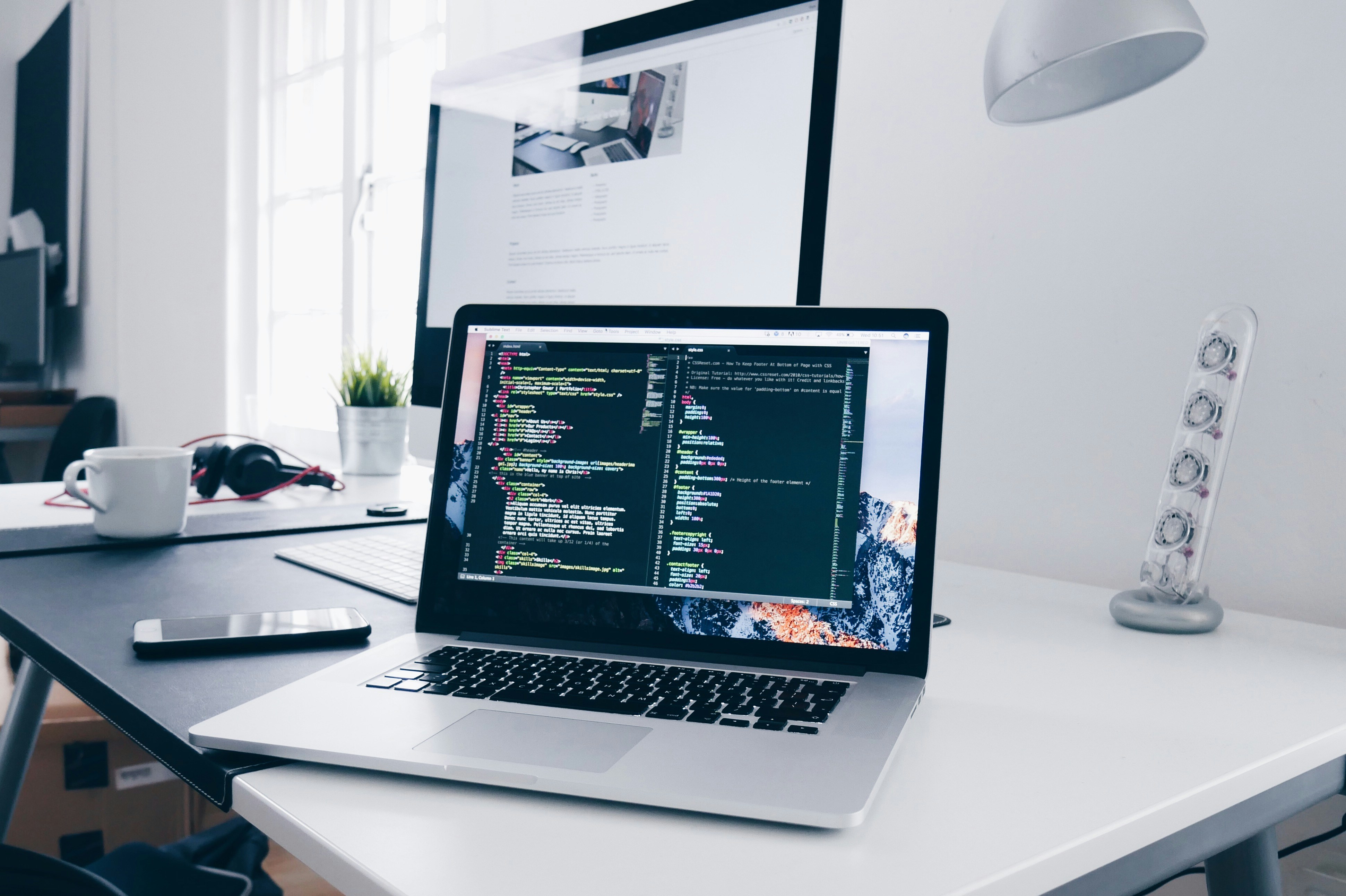 Tech innovation workspace with code on screen